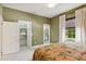 Charming bedroom with a floral comforter and en-suite bathroom at 3973 Boca Pointe Dr, Sarasota, FL 34238