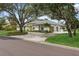 House exterior with mature trees and a large yard at 3973 Boca Pointe Dr, Sarasota, FL 34238