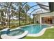 Enclosed pool and spa with lush landscaping at 3973 Boca Pointe Dr, Sarasota, FL 34238