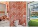 Small bathroom with coral wallpaper and pool view at 3973 Boca Pointe Dr, Sarasota, FL 34238