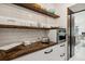 Well-equipped kitchen with open shelving, built-in microwave, and white subway tile at 3973 Boca Pointe Dr, Sarasota, FL 34238