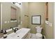Simple bathroom with toilet, sink, and decorative art at 3973 Boca Pointe Dr, Sarasota, FL 34238
