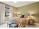 Bright bedroom with floral bedding and two ottomans at 3973 Boca Pointe Dr, Sarasota, FL 34238