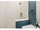 Modern bathroom with white tile shower and blue accents at 3973 Boca Pointe Dr, Sarasota, FL 34238