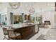 Open kitchen with marble island, breakfast bar, and pool view at 3973 Boca Pointe Dr, Sarasota, FL 34238