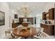 Elegant dining room with a round table and modern chandelier at 3973 Boca Pointe Dr, Sarasota, FL 34238