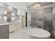 Spa-like bathroom featuring a soaking tub, double vanity, and walk-in closet at 3973 Boca Pointe Dr, Sarasota, FL 34238
