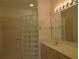 Bathroom with glass block shower and a vanity at 4939 Lakescene Pl, Sarasota, FL 34243
