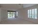 Bright living room with sliding glass doors leading to a patio and view of water at 4939 Lakescene Pl, Sarasota, FL 34243