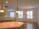 Bright kitchen with tile floors, light wood cabinets, and an island at 4939 Lakescene Pl, Sarasota, FL 34243