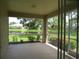 Spacious screened patio overlooking a lake and lush landscaping at 4939 Lakescene Pl, Sarasota, FL 34243