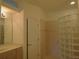 Primary bathroom with glass block shower and double vanity at 4939 Lakescene Pl, Sarasota, FL 34243
