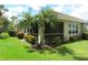 Home exterior showcasing a screened patio and well-manicured lawn at 4939 Lakescene Pl, Sarasota, FL 34243
