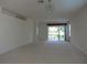 Bright living room with sliding doors to patio and lake view at 4939 Lakescene Pl, Sarasota, FL 34243