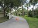 Private paved driveway with lush landscaping at 4939 Lakescene Pl, Sarasota, FL 34243