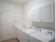 Laundry room with washer, dryer, sink, and cabinets at 4939 Lakescene Pl, Sarasota, FL 34243