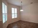 Bright dining area with tile flooring and stylish light fixtures at 4939 Lakescene Pl, Sarasota, FL 34243