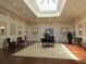 Spacious lobby with hardwood floors, high ceilings, and comfortable seating at 4939 Lakescene Pl, Sarasota, FL 34243