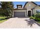 Two-story house with gray garage door and landscaping at 5828 Pomarine Ct, Sarasota, FL 34238