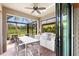 Outdoor kitchen with granite countertops, a grill, and dining area at 5828 Pomarine Ct, Sarasota, FL 34238