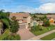 Tan two-story house with brown roof and landscaping at 5828 Pomarine Ct, Sarasota, FL 34238