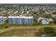 Aerial view of condo building with surrounding landscape and pool at 3790 Pinebrook Cir # 103, Bradenton, FL 34209