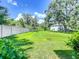 Backyard with grassy lawn and privacy fence at 6428 Boxgrove Dr, Sarasota, FL 34240