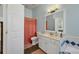 Bathroom with shower/tub combo, vanity, and coral shower curtain at 5111 51St W Ln, Bradenton, FL 34210