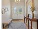 Bright entryway with tiled floor, bench, and decorative mirrors at 5111 51St W Ln, Bradenton, FL 34210