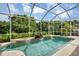 Screened pool and spa with fountain and lush landscaping at 5111 51St W Ln, Bradenton, FL 34210