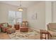 Bright sitting room with two armchairs and ottoman, ideal for relaxing at 5111 51St W Ln, Bradenton, FL 34210