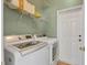 Laundry room with LG washer and dryer, and ample storage at 5111 51St W Ln, Bradenton, FL 34210