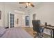Bedroom with wood-look flooring, French doors, and home office space at 5111 51St W Ln, Bradenton, FL 34210