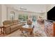 Relaxing living room with leather sofas, a large TV, and access to the pool area at 5111 51St W Ln, Bradenton, FL 34210