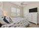 Bedroom with white dresser, patterned bedding and large window at 5111 51St W Ln, Bradenton, FL 34210