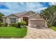 One-story home with a red door and palm trees at 5111 51St W Ln, Bradenton, FL 34210