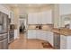 Large kitchen with white cabinets, granite counters & stainless steel appliances at 5111 51St W Ln, Bradenton, FL 34210