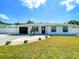 Front view of a renovated house with a new garage door at 2845 Indianwood Dr, Sarasota, FL 34232