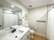 Modern bathroom with white vanity, quartz countertop, and a large mirror at 2845 Indianwood Dr, Sarasota, FL 34232