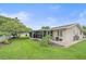 Landscaped backyard with a large screened porch at 2611 Sunnyside St, Sarasota, FL 34239