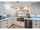 Modern kitchen with white cabinets, stainless steel appliances, and a farmhouse sink at 2611 Sunnyside St, Sarasota, FL 34239
