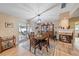 Dining room with a wooden table and chairs, fireplace, and access to the back patio at 2611 Sunnyside St, Sarasota, FL 34239