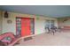 Covered porch with seating and red door at 2611 Sunnyside St, Sarasota, FL 34239