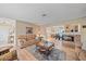 Open concept living room with a fireplace and a view into the dining area and kitchen at 2611 Sunnyside St, Sarasota, FL 34239