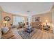 Spacious living room featuring light colored hardwood floors and comfortable seating at 2611 Sunnyside St, Sarasota, FL 34239