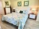 King-size bed, light wood floors, and coastal decor at 6611 Stone River Rd # 104, Bradenton, FL 34203