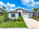 One-story home with a two-car garage and landscaping at 9025 Tequila Sunrise Dr, Sarasota, FL 34241