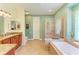 Spa-like bathroom with soaking tub, walk-in shower, and double vanity at 7606 91St E St, Palmetto, FL 34221
