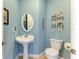 Charming half bathroom with pedestal sink and decorative shelving at 7606 91St E St, Palmetto, FL 34221