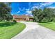 Home features a three-car garage and circular driveway at 7606 91St E St, Palmetto, FL 34221